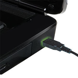Close-up of a laptop USB port with a cable connected, indicating charging status.