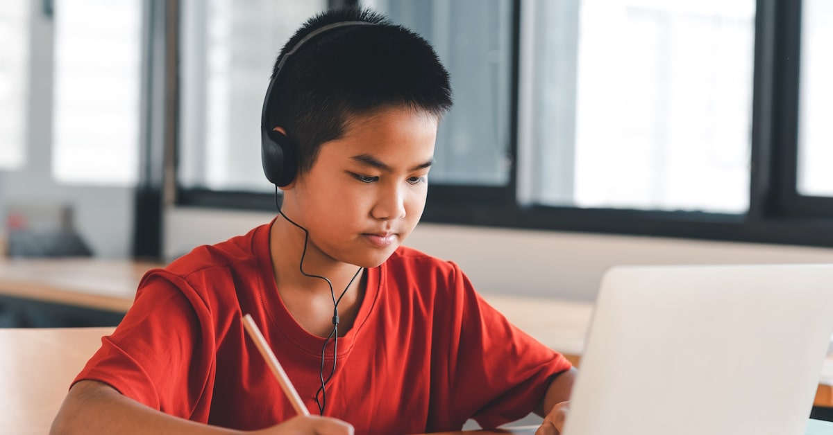 Student using durable and comfortable classroom headphones during focused learning