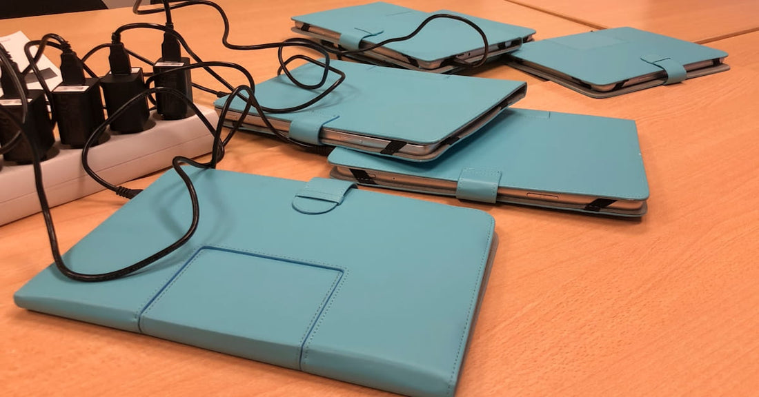 multiple mobile devices on a table charging 