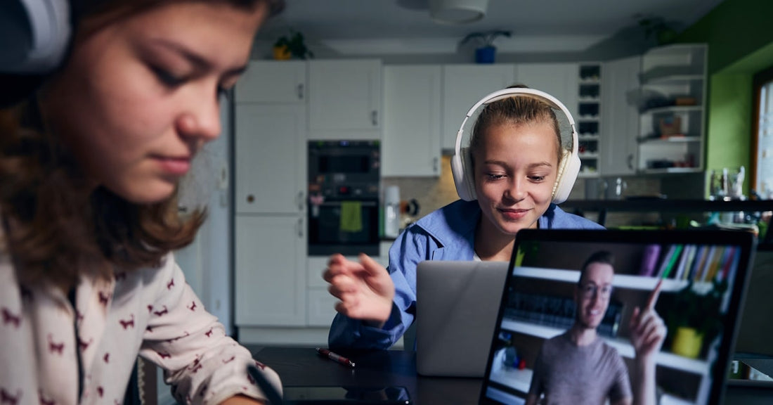 Students wearing classroom headphones while participating in online testing and digital learning activities