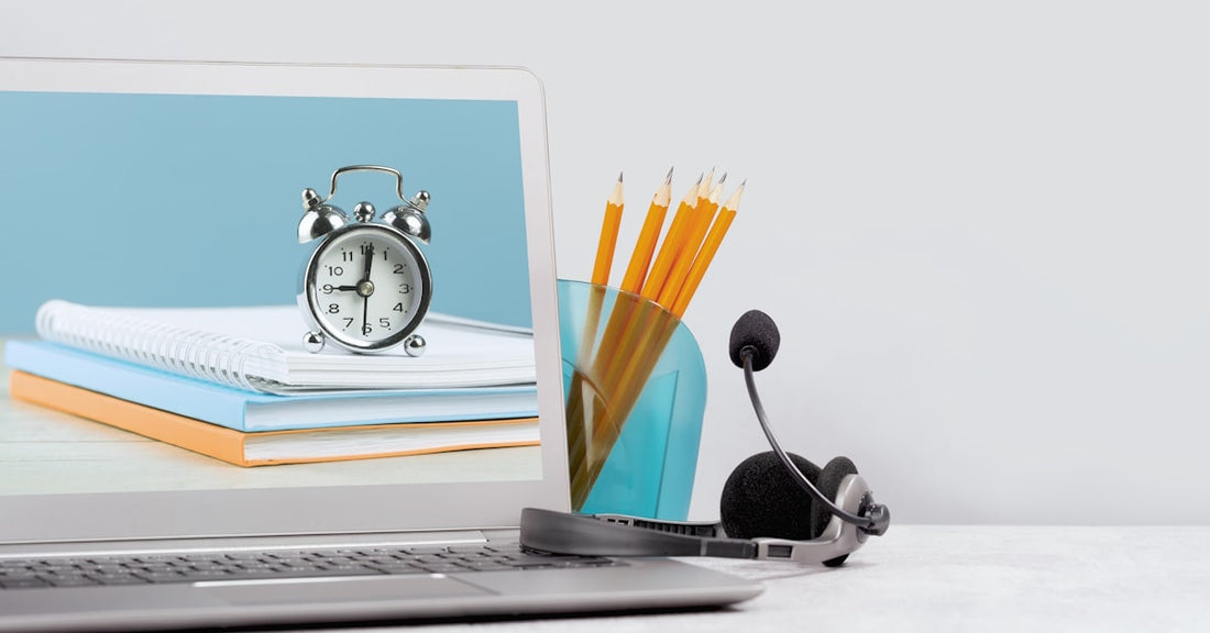 Classroom listening center setup with laptop, headset, and school supplies