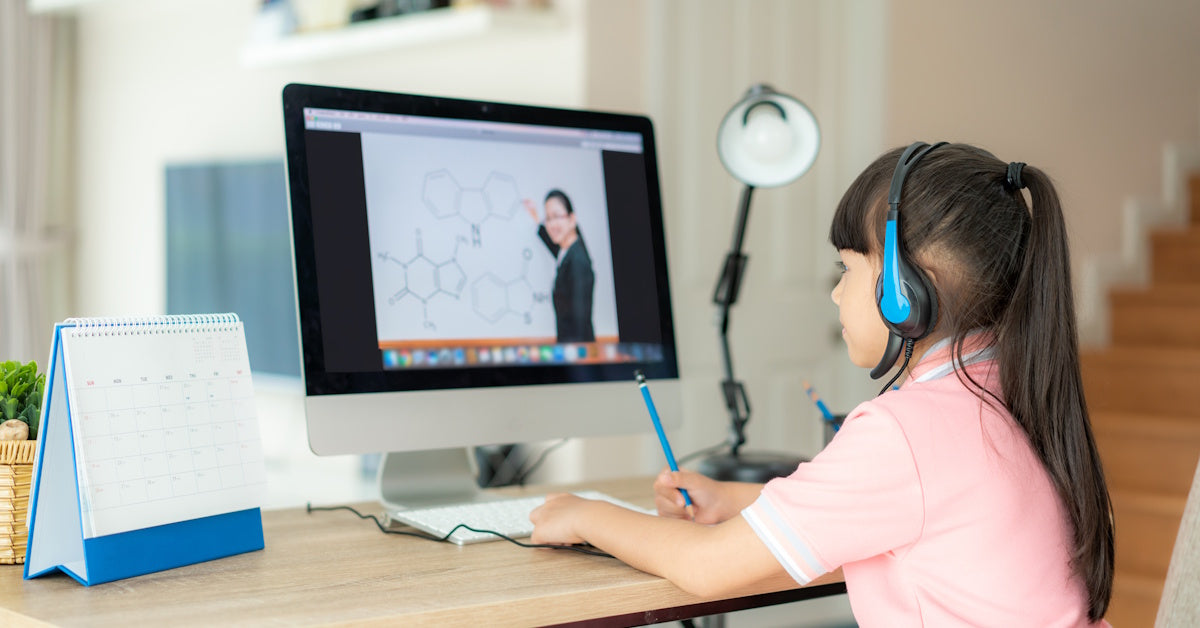 school headphones being worn by a student in classroom setting