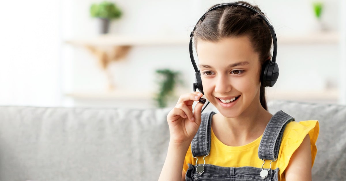 Student wearing a classroom headset with microphone for language learning practice