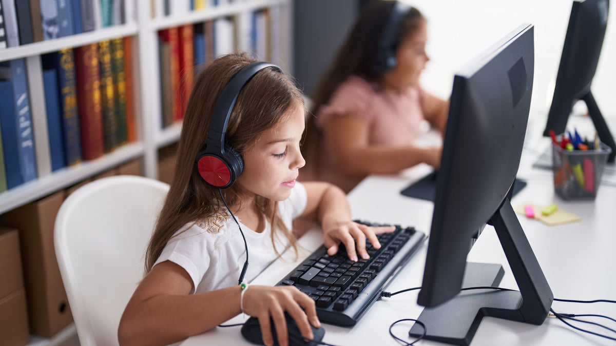 students at a computer with headphones taking a test