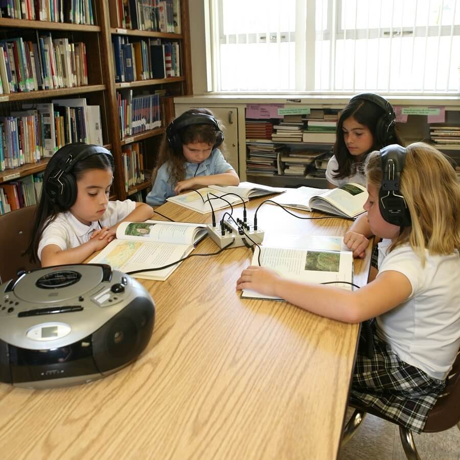 Kids using Califone 3068AV-CT school headphones during a classroom learning activity.