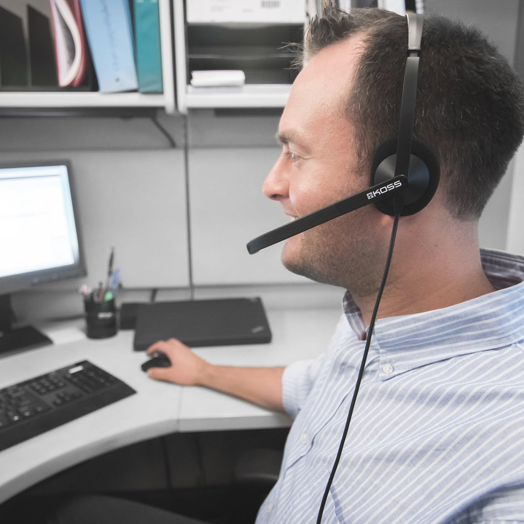 Koss CS200-USB headset in use at an office desk, ideal for bulk school headphones and virtual meetings.