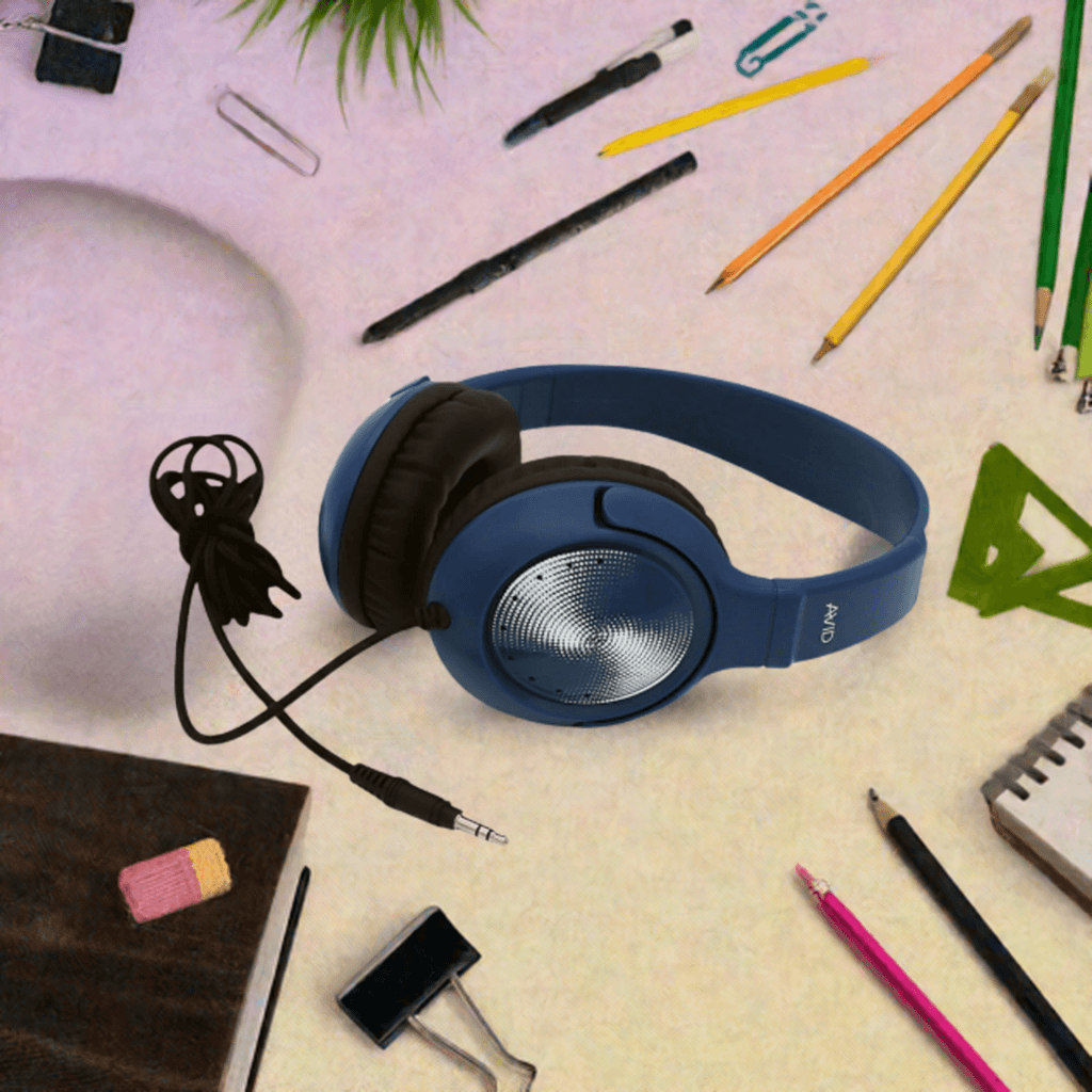 AE-54 Classroom Headphones - Blue on a desk surrounded by school supplies.