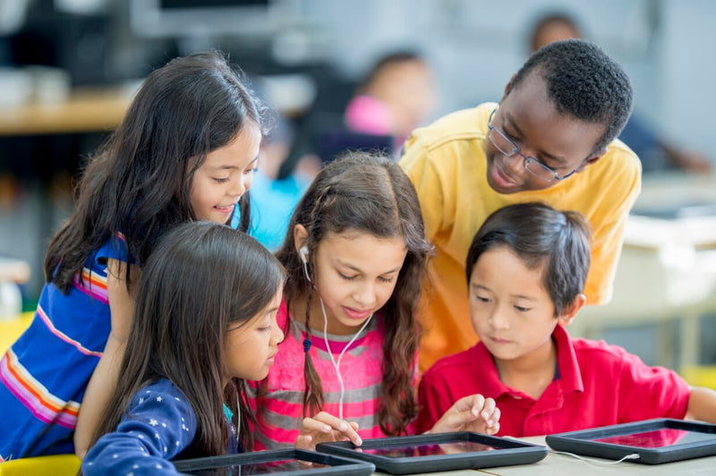 Students sharing a tablet with school earbuds
