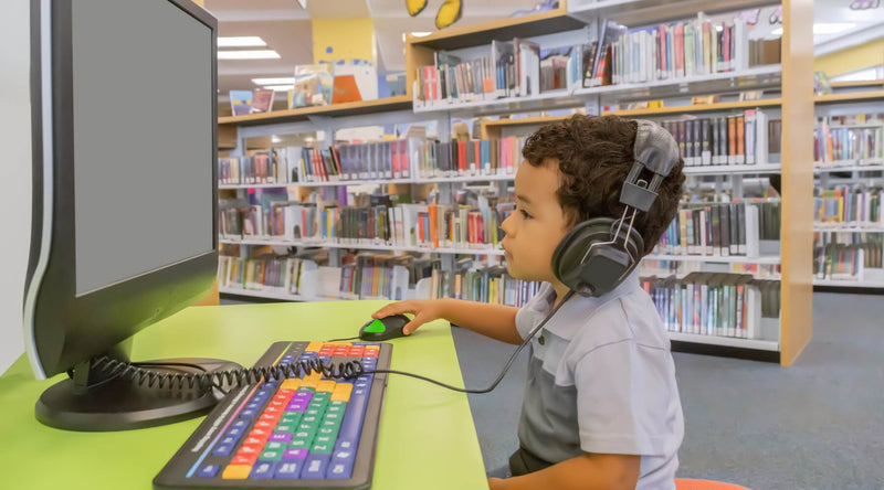 Student using a headset at a library computer