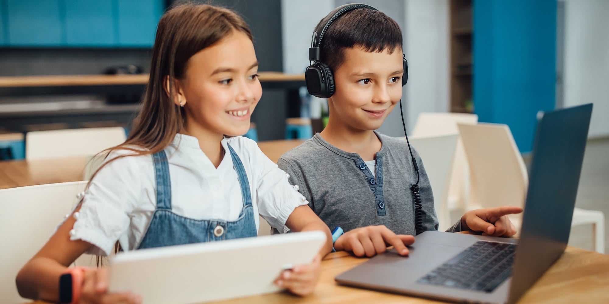 Students using school headphones for digital classroom learning