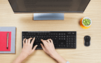 Logitech MK270 Wireless Keyboard & Mouse Combo with hands typing and monitor on a desk