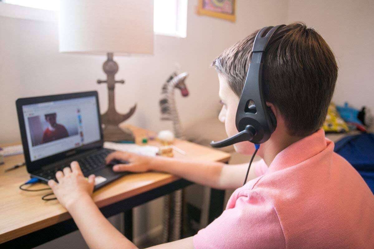 Student using ThinkWrite Ultra Ergo Headset TW-110 for online learning, ideal bulk school headphones for education.