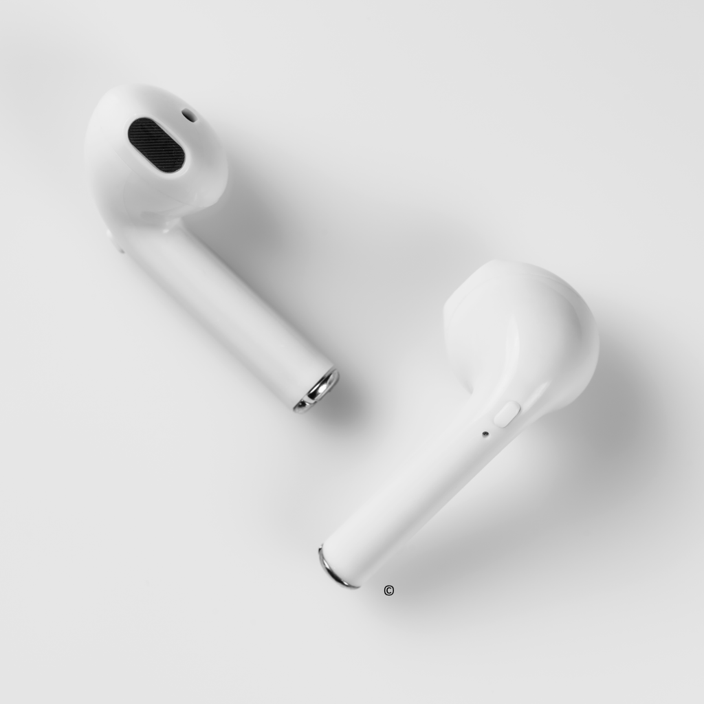 White wireless earbuds designed for school use, perfect for students and teachers wanting bulk school headphones.